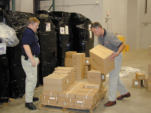 Bill Strang and Jay Hensley (TSSi’s Sales Manager at the time) sort equipment onto pallets for delivery to the NYPD Emergency Services Unit.